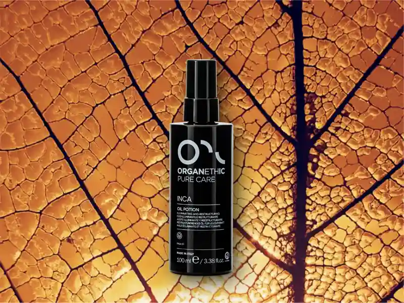 Bottle of Inca Illuminating Restructuring Oil Potion on a large golden leaf.