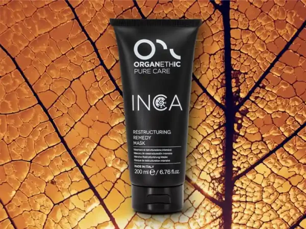 A large tube of Inca Restructuring Remedy Mask on a golden leaf.