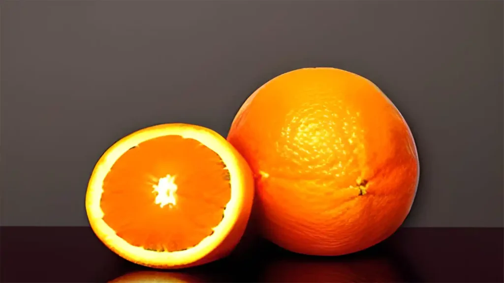 two oranges one cut and one whole
