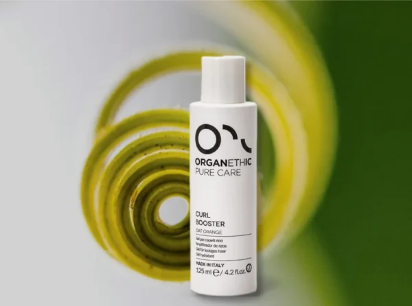 Bottle of Curl Booster for styling curly hair.