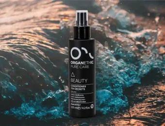 Organethic Pure Care Beauty Conditioner Ten Secrets with sea in the background.